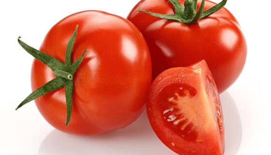 Three ripe red tomatoes on a white background—two whole and one cut to reveal the juicy interior.